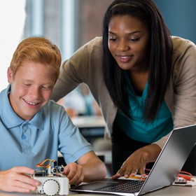 A teacher helps a student.