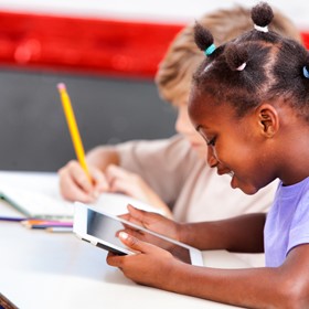 Two students practice their writing