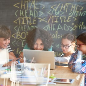 Kids coding at a laptop