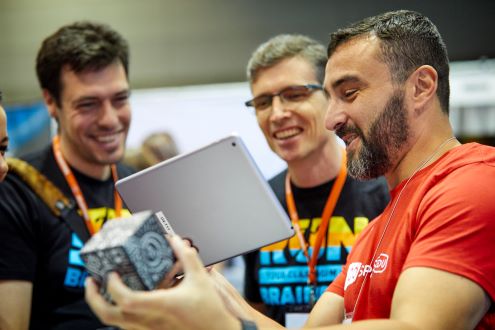 Three educators try out a Merge Cube at the ISTE Conference & Expo.