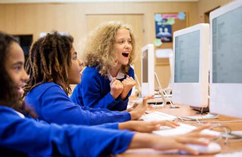 Three students work on coding project