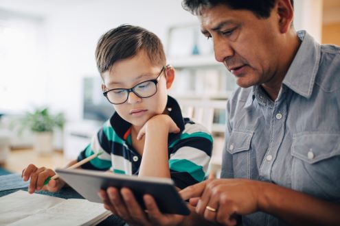 A parent helps a child with homework