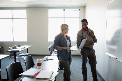 Two teachers work on lesson plans