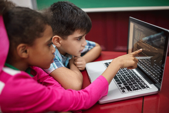 Two students work on coding project on a laptop.