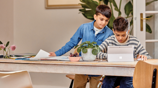 Two students use a tablet