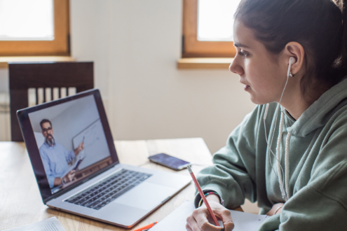 a college student is learning online from her home