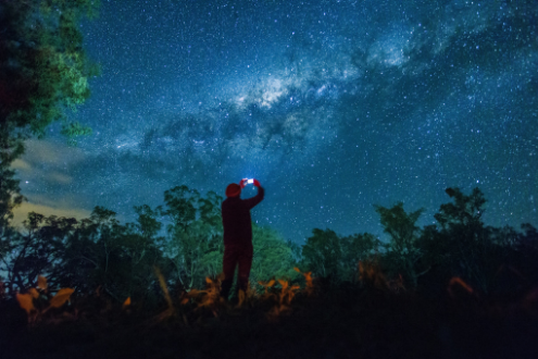 Person takes photo of night sky with smartphone