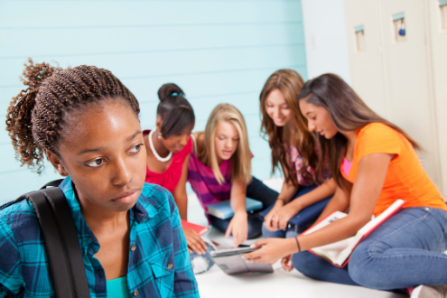 A girl is excluded from a group of girls at school