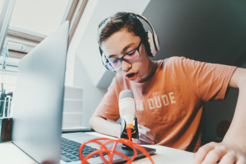 A teen boy podcasting