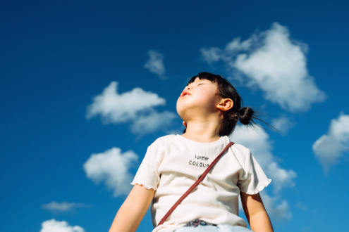 A girl looks at the clouds
