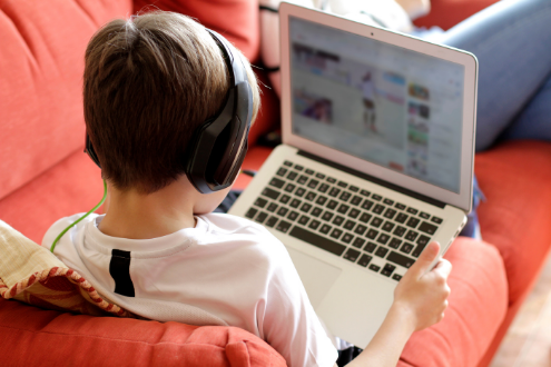 A student learns at home on his laptop