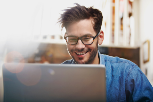 A man with a laptop attending a virtual conference