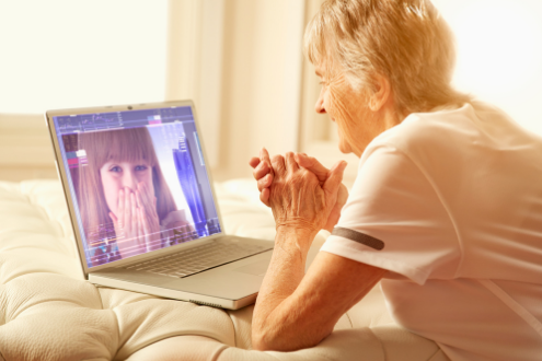 A woman talks to her grand daughter on a video call. 