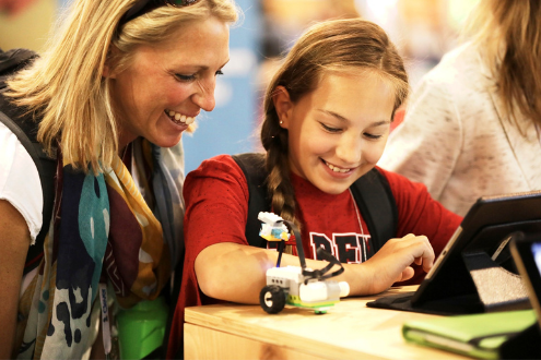 A student demonstrates a robot