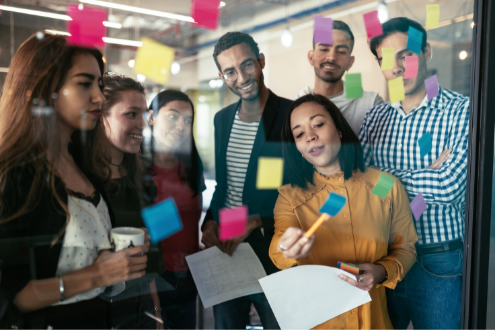 a group of teachers collect ideas on sticky notes