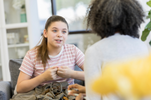a girl talks to her teacher