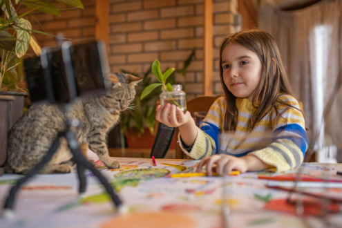 A girl filming a video about a plant project