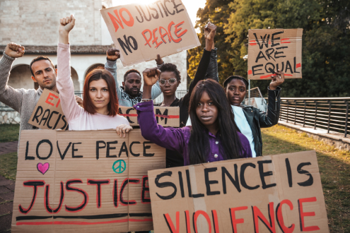 students hold anti-racism signs during a demonstration
