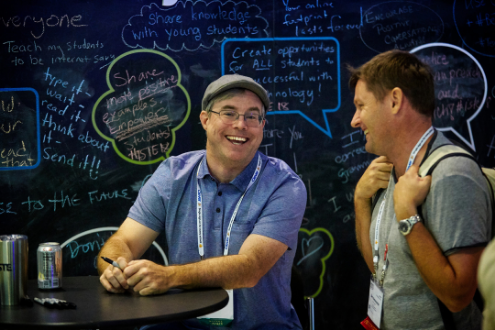 Two male educators share a laugh at a lounge at the ISTE conference