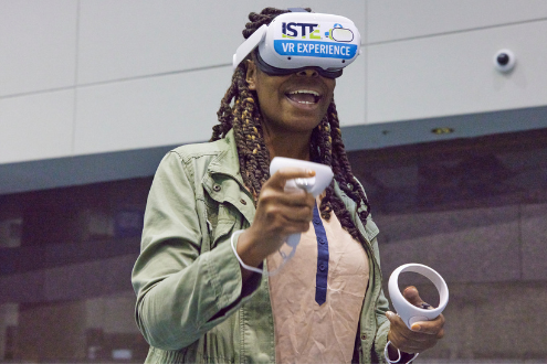 A woman tries out a VR headset at ISTELive 22