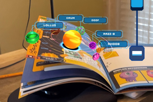 A book opens to a 3D images showing what augmented reality looks like on a device. 