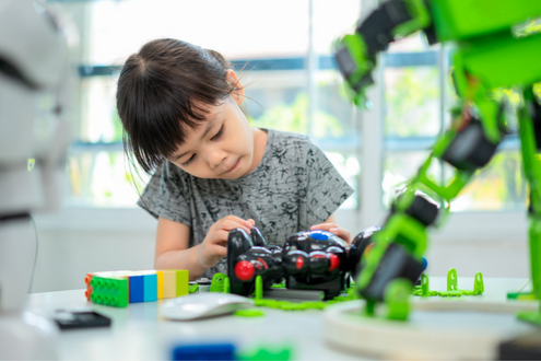 A girl works on a robotics project in the school library