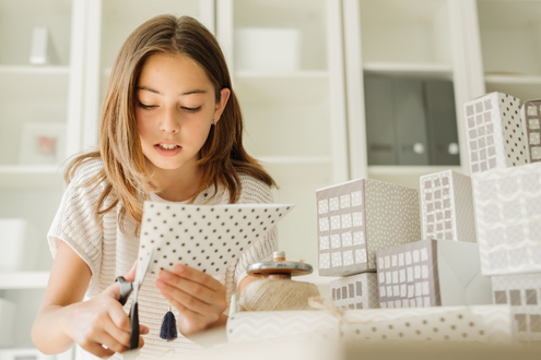 A girl cuts paper for a school project