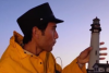 A screenshot from a Zach King TikTok showing him holding a tiny lighthouse