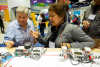 Two women explore a robotics tool at the Expo Hall at ISTE19