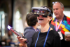 An educator at ISTELive 23 smiles as she wears an AR headset